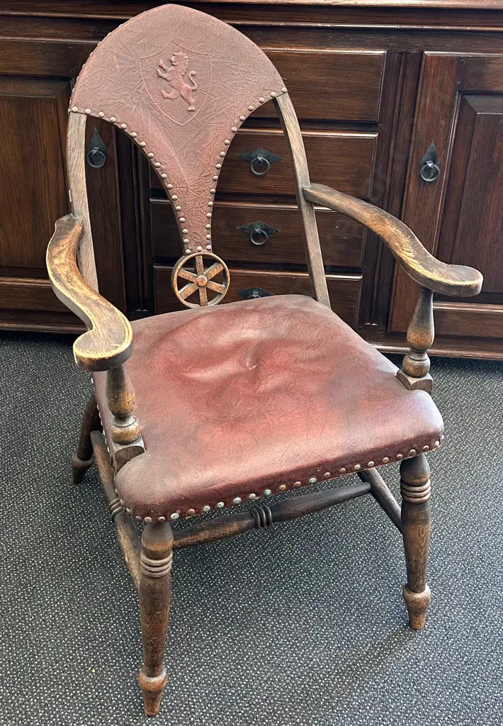 Oak and Leather Elbow Chair with an embossed Lion Sheild Image 1++