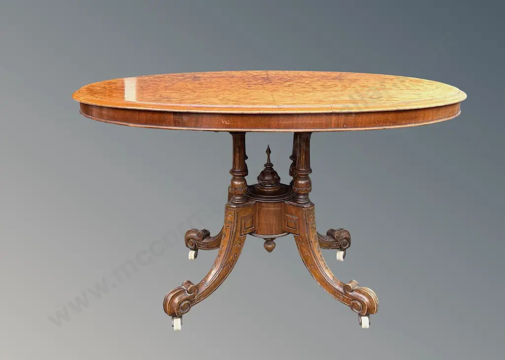 Burr Walnut Oval Loo Table on Ornately Carved Four Point Base with Porcelain Castors L122xH69xW89cm Image 1++